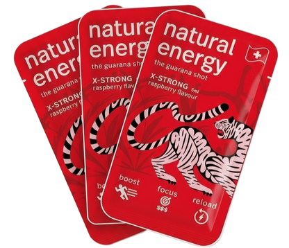 Three X Strong Raspberry packages of 'Natural Energy' guarana shots with a tiger design on a red background.