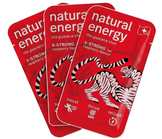 Three X Strong Raspberry packages of 'Natural Energy' guarana shots with a tiger design on a red background.