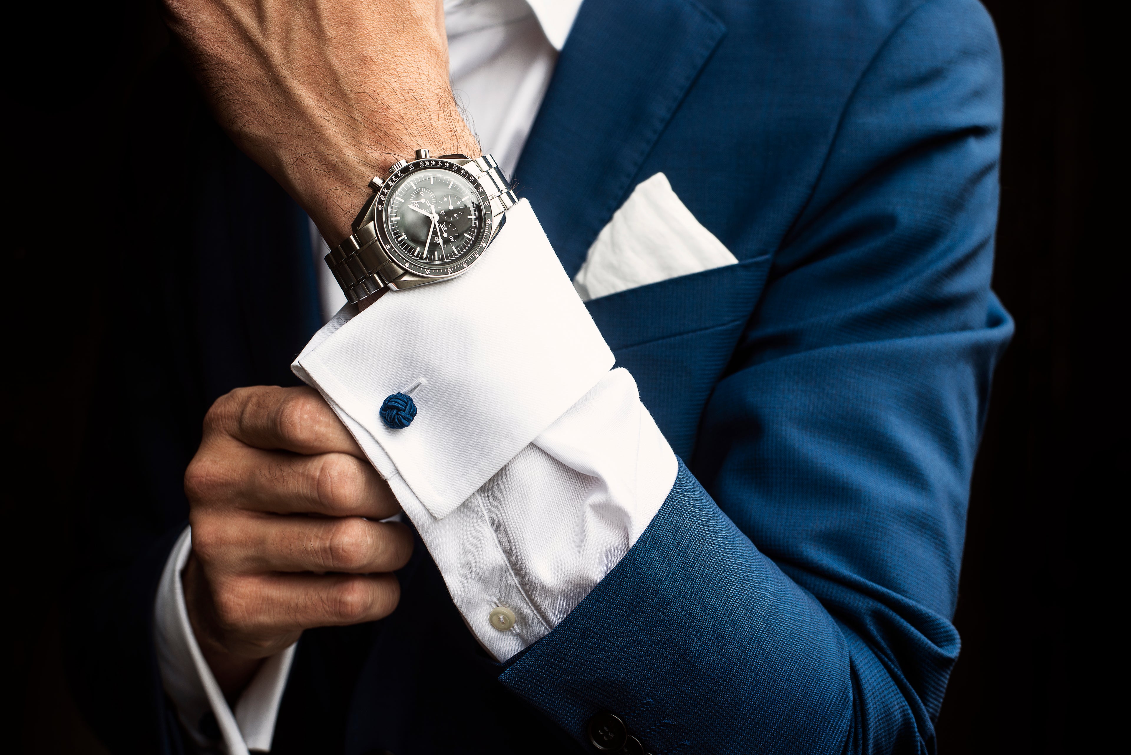 man-adjusts-his-shirt-cuffs-below-watch