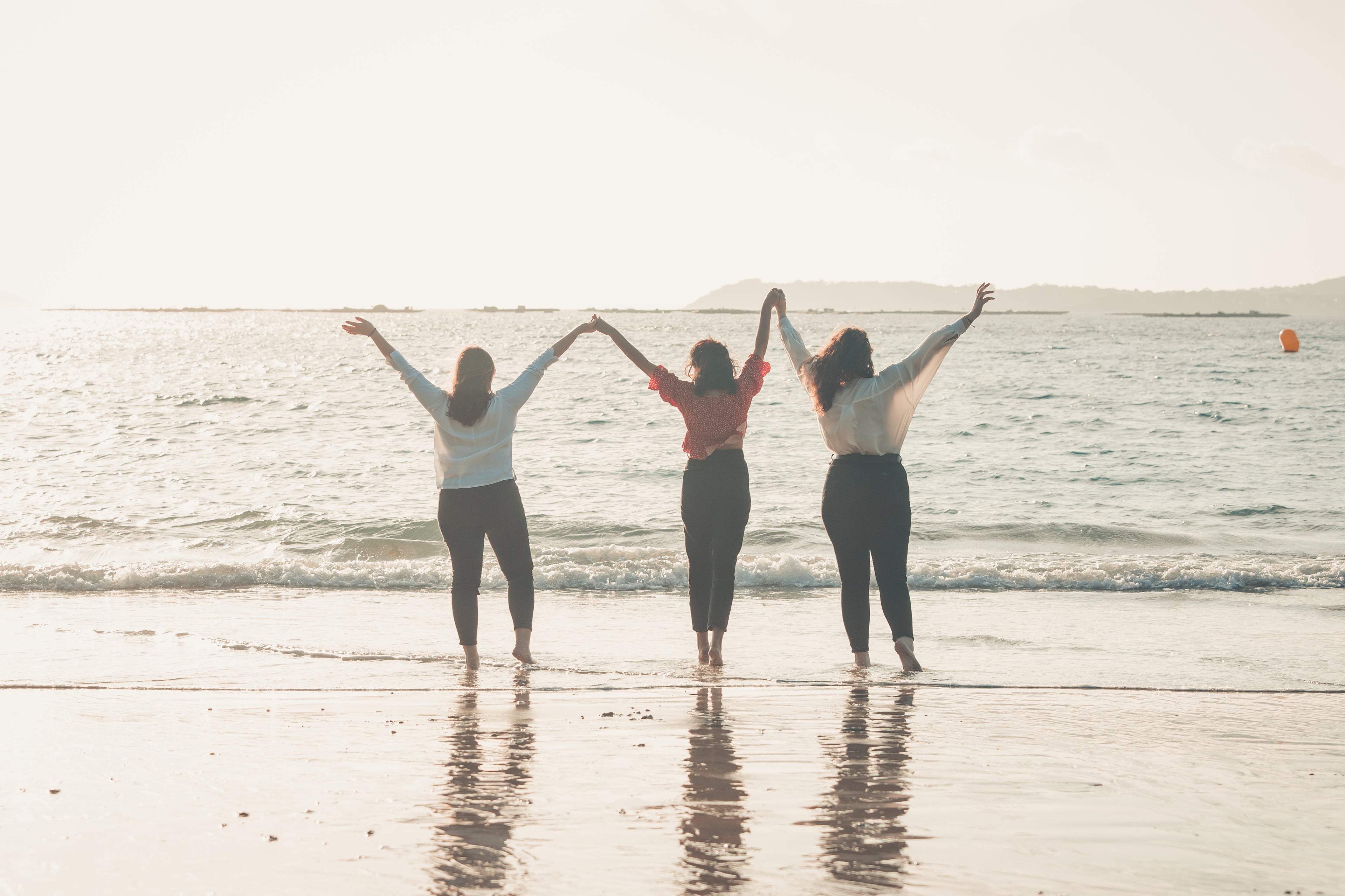 three-people-hold-hands-with-their-arms-to-the-sky-shouting-natural-energy-today-is-the-best